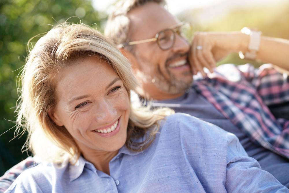 A laughing couple with dental implants