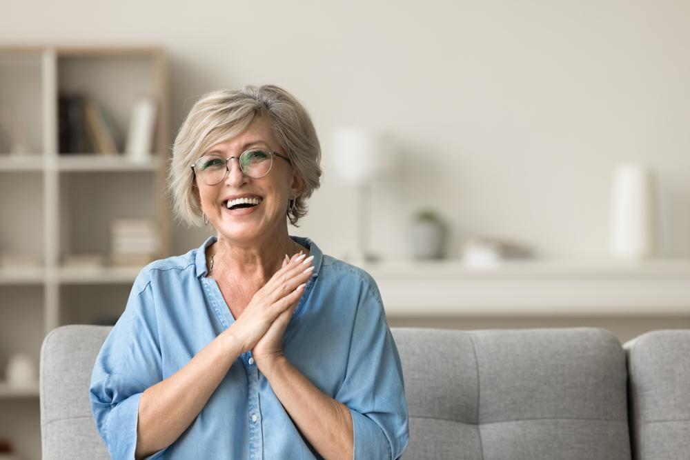An older woman excited about dental crowns and bridges