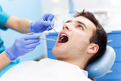 A man getting a dental exam in Indianapolis
