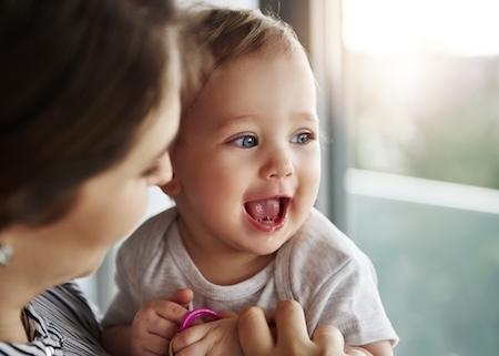 A laughing baby and her mother