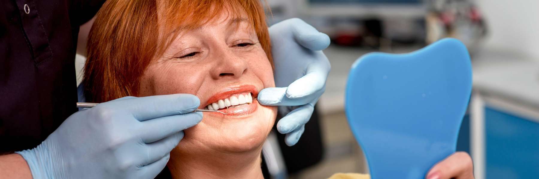A happy woman looking at her finished smile