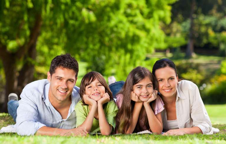 A family laying in the grass