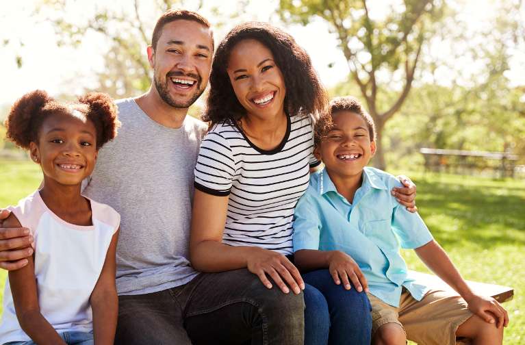 A smiling family in the park